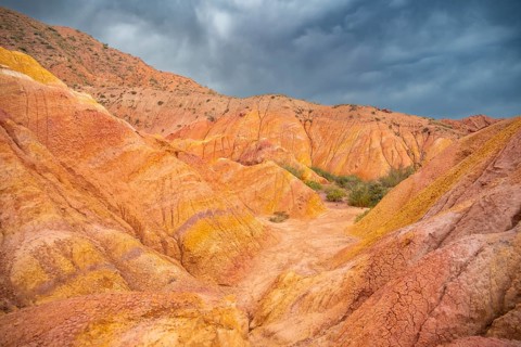 Eroded mountain landscape, sandstone cliffs, canyon with red and orange rock formations, Konorchek