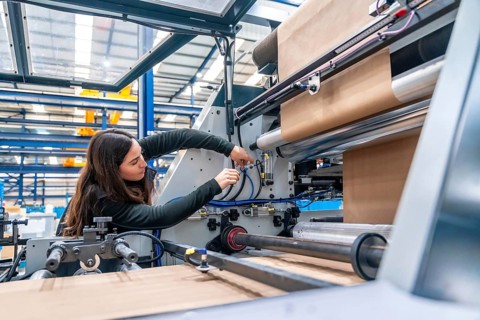 Side view with copy space of a Engineer working on a machine in a cnc modern factory