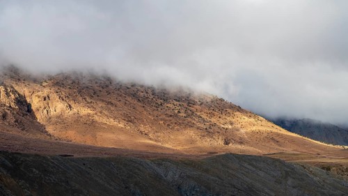 Low hanging clouds in the mountain landscape at the Tizi-n-Tichka pass road, High Atlas, Morocco,