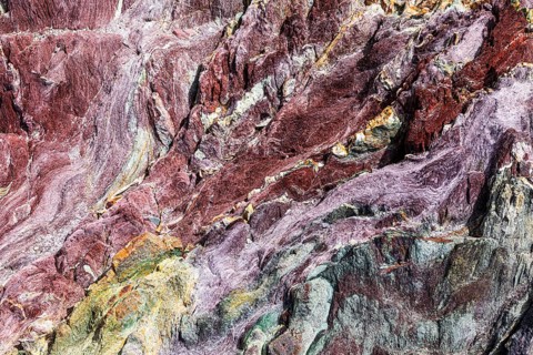 Coloured, ferrous mineral rocks on the beach of Topinetti, near Rio Marina, Elba, Tuscan
