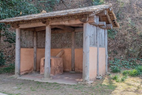Thatched hut containing terracotta forging oven used at ship building site in Yeosu, South Korea,