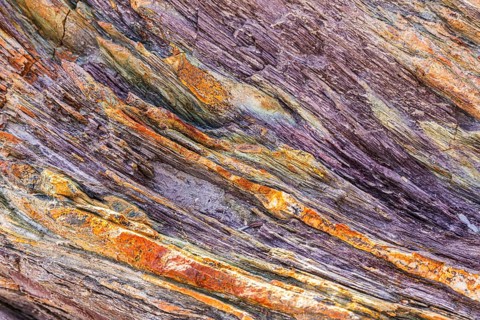 Coloured, ferrous mineral rocks on the beach of Topinetti, near Rio Marina, Elba, Tuscan