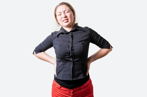 Suffering girl with back pain. Young woman with back pain. Lumbar problems concept. People with