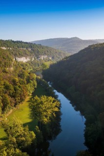 River with gorge and autumnal coloured forest, valley of the Loue, Lizine, near Besancon,