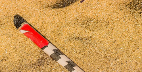 Spend roman candle laying in the sand on a beach