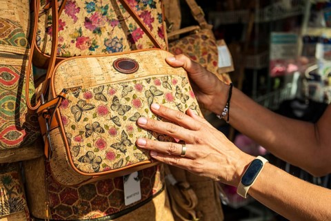Woman buying a vintage cork bag, Coimbra