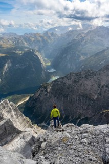 Mountaineer on the rocky summit of the Watzmann Mittelspitze, Watzmann crossing, view of mountain