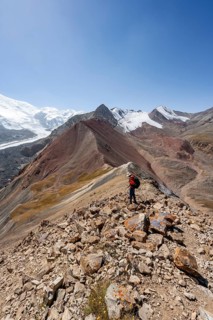 Mountaineer at Traveller's Pass with view of impressive mountain landscape, high mountain landscape