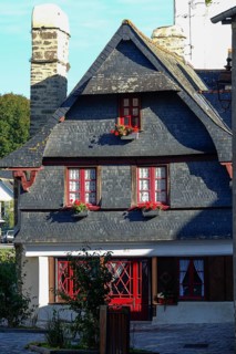 Rue du General de Gaulle in the old town centre of Le Faou with slate-roofed granite houses from