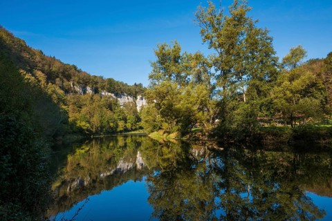 River with gorge and autumnal coloured forest, valley of the Loue, Lizine, near Besancon,