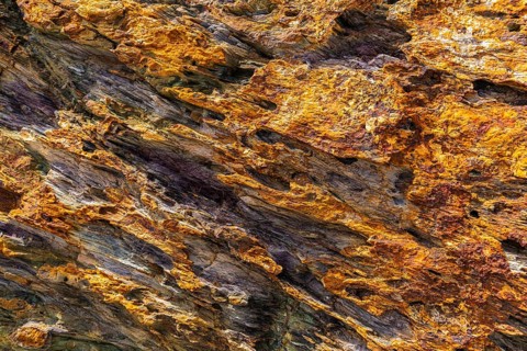 Coloured, ferrous mineral rocks on the beach of Topinetti, near Rio Marina, Elba, Tuscan