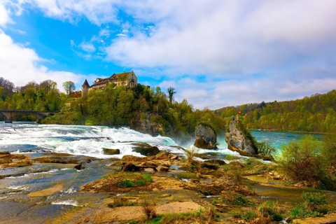 Rhine Falls and Swiss Flag with the Castle Laufen at Neuhausen in Schaffhausen, Switzerland, Europe