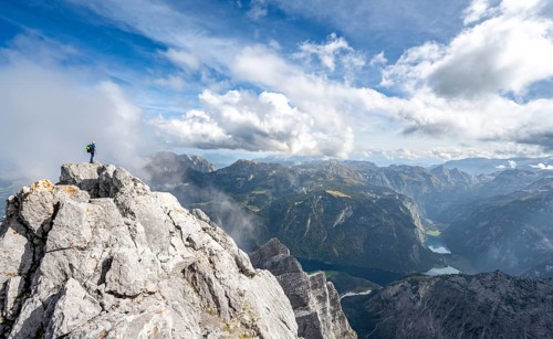 Mountaineer on the rocky summit of the Watzmann Mittelspitze, Watzmann crossing, view of mountain