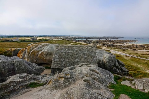 Former village of Meneham on the Atlantic coast with house between granite rocks, coast on the