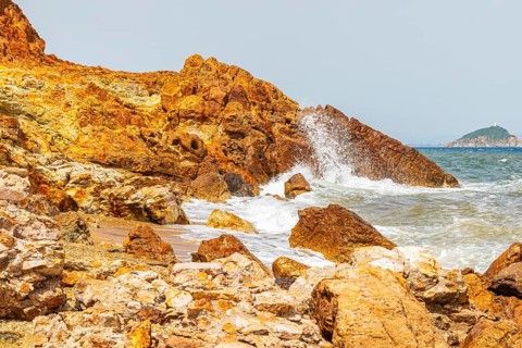 Mineral rocks washed by the sea on the beach of Topinetti, near Rio Marina, Elba, Tuscan