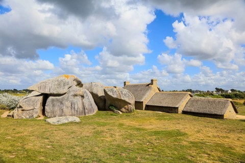 Former village of Meneham on the Atlantic coast with partly thatched houses between granite rocks,