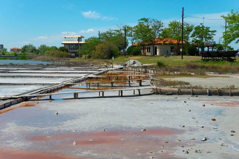 Salt extraction plant with natural landscape in the background and a clear blue sky, therapeutic