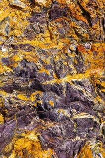 Coloured, ferrous mineral rocks on the beach of Topinetti, near Rio Marina, Elba, Tuscan