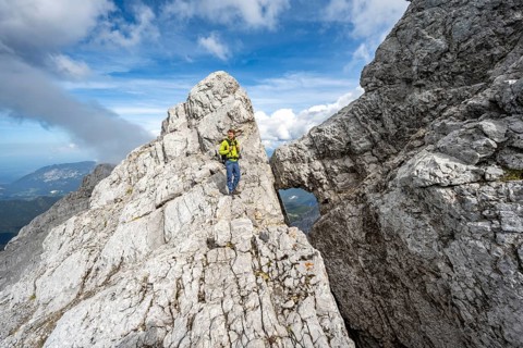 Mountaineer on a narrow rocky ridge, Watzmann crossing to Watzmann Mittelspitze, view of mountain
