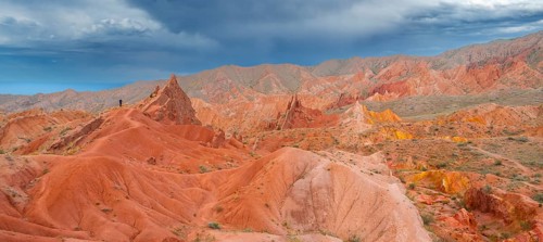 Eroded mountain landscape, sandstone cliffs, canyon with red and orange rock formations, Konorchek