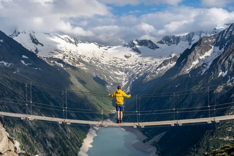 Mountaineers on a suspension bridge, picturesque mountain landscape near the Olpererhuette, view of