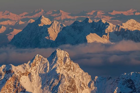 Mountain peak in the snow in the evening light, high fog, distant view, view from Zugspitze to