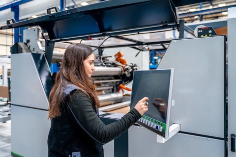 Female concentrated worker using cnc machine to control an industrial crane