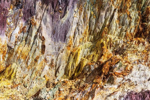 Coloured, ferrous mineral rocks on the beach of Topinetti, near Rio Marina, Elba, Tuscan