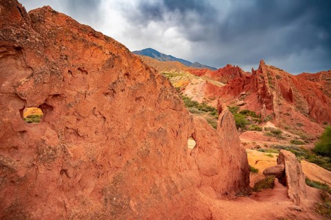 Eroded mountain landscape, sandstone cliffs, canyon with red and orange rock formations, Konorchek