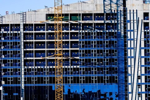 Yeoso, South Korea: December 25, 2017: Yellow crane attached to side of building that is under