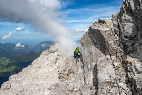 Mountaineer on a narrow rocky ridge, Watzmann crossing to Watzmann Mittelspitze, view of mountain