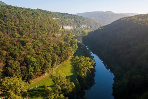 River with gorge and autumnal coloured forest, valley of the Loue, Lizine, near Besancon,