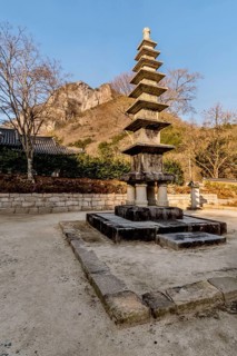 Nine story stone carved Buddhist pagoda in mountain temple under blue sky