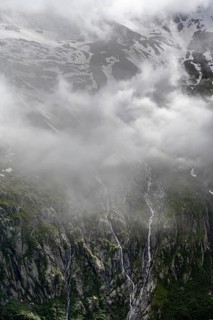 Cloudy mountain landscape, mountain streams as waterfalls on a mountain slope, Furtschaglhaus,