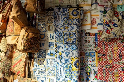 Market stand with cork bags, table cloth with traditional ornaments at city market