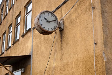 Stagnant, old clock on decaying building, symbol of transience, passage of time, ageing, need for