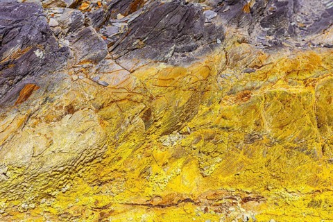 Coloured, ferrous mineral rocks on the beach of Topinetti, near Rio Marina, Elba, Tuscan