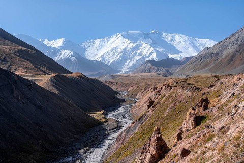 Valley with river Achik Tash between high mountains, mountain landscape with peak Pik Lenin, Osh