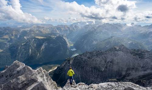 Mountaineer on the rocky summit of the Watzmann Mittelspitze, Watzmann crossing, view of mountain