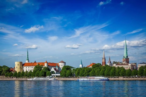 View of Riga over Daugava river: Riga Castle, St. James's Cathedral, St. Peter's Church. Riga,