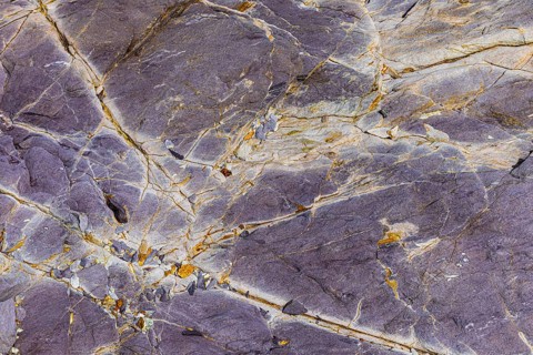 Coloured, ferrous mineral rocks on the beach of Topinetti, near Rio Marina, Elba, Tuscan