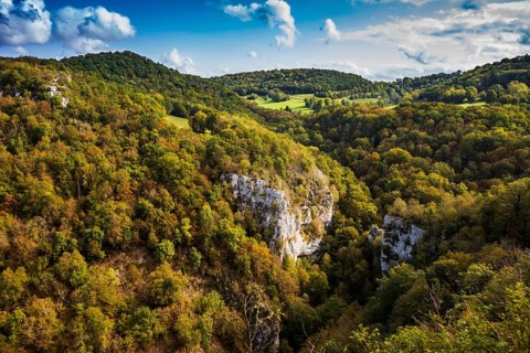 River with gorge and autumnal coloured forest, valley of the Loue, Lizine, near Besancon,