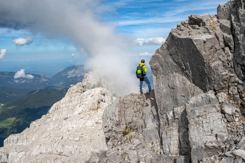 Mountaineer on a narrow rocky ridge, Watzmann crossing to Watzmann Mittelspitze, view of mountain