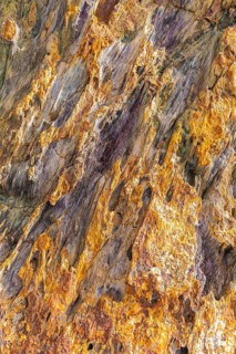 Coloured, ferrous mineral rocks on the beach of Topinetti, near Rio Marina, Elba, Tuscan