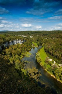 River with gorge and autumnal coloured forest, valley of the Loue, Lizine, near Besancon,