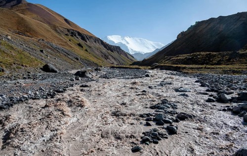 Valley with river Achik Tash between high mountains, mountain landscape with peak Pik Lenin, Osh