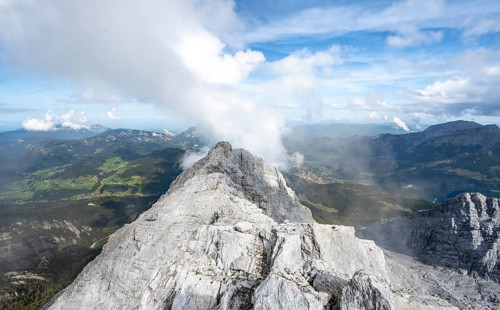 Rocky narrow mountain ridge with summit Watzmann Hocheck, view from Watzmann middle summit to
