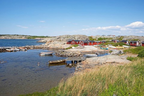 Red wooden houses on the archipelago island of Hoenoe, Oeckeroe municipality, Vaestra Goetalands