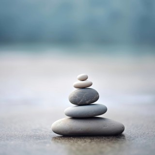Zen stones stack on sand waves in a minimalist setting for balance and harmony. Balance, harmony,