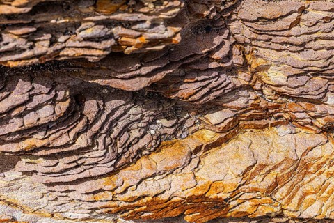 Coloured, ferruginous mineral sandstone on Topinetti beach, near Rio Marina, Elba, Tuscan